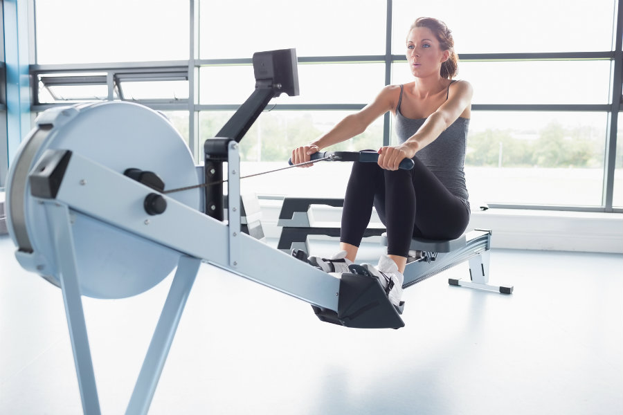 bigstock-Woman-training-on-row-machine--39322954