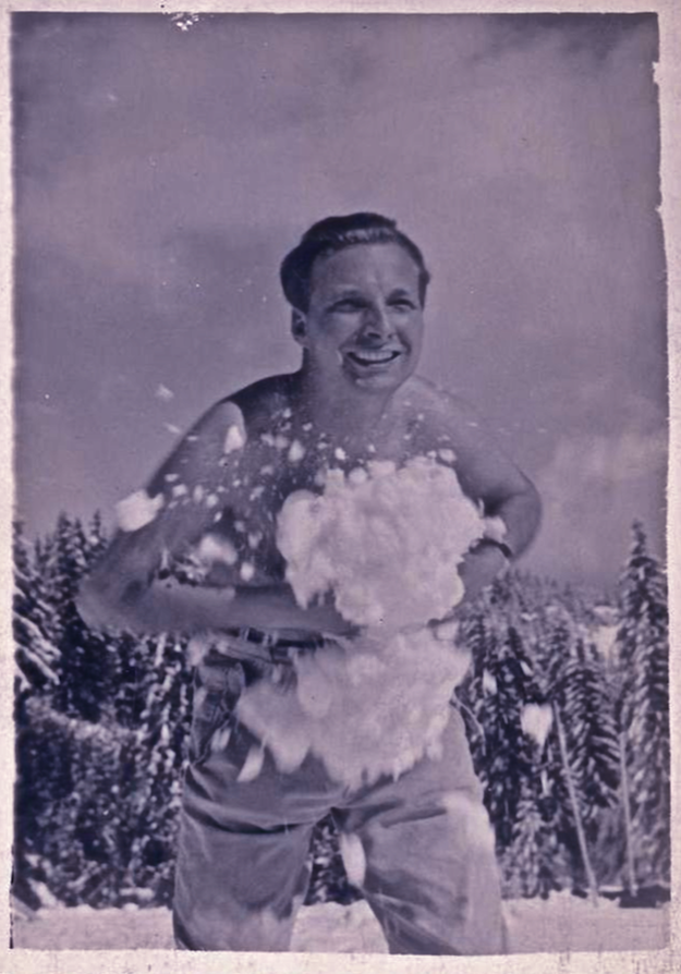 1950s Shirtless Man In Snow With Giant Snow Boulder